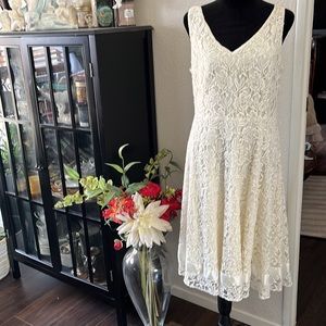 White lace party dress with a silk trim on the bottom ribbon completely lined